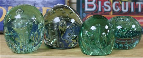 Four bubble inclusion glass dump paperweights, one an inkwell